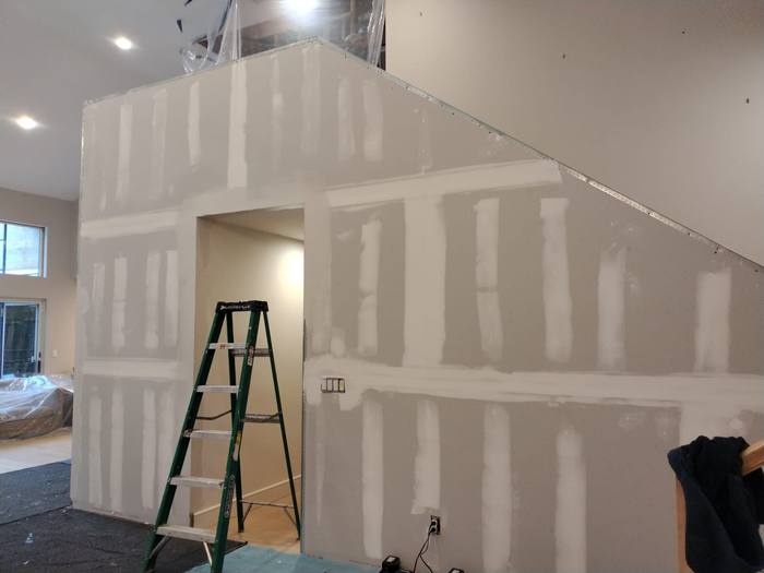 Drywall and spackle repair on an interior wall before painting