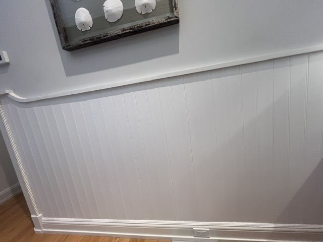 Painted beadboard wainscoting with rope trim in a Hamptons home