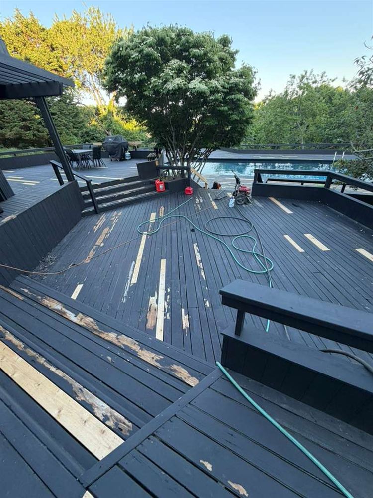 Pool deck mid-prep with sanded, peeling boards and new replacement planks