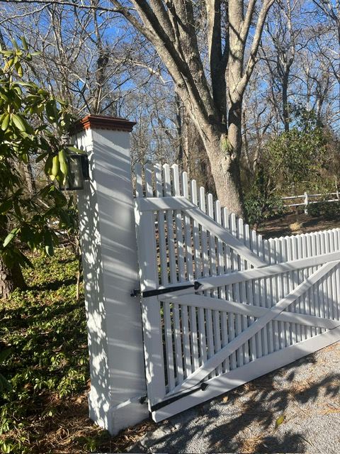 Painted driveway gate and column at a Hamptons property