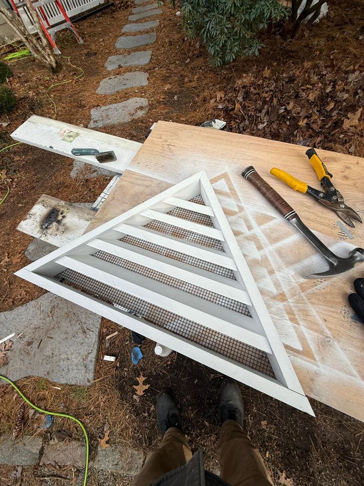 Triangular gable vent rebuilt and primed before reinstalling