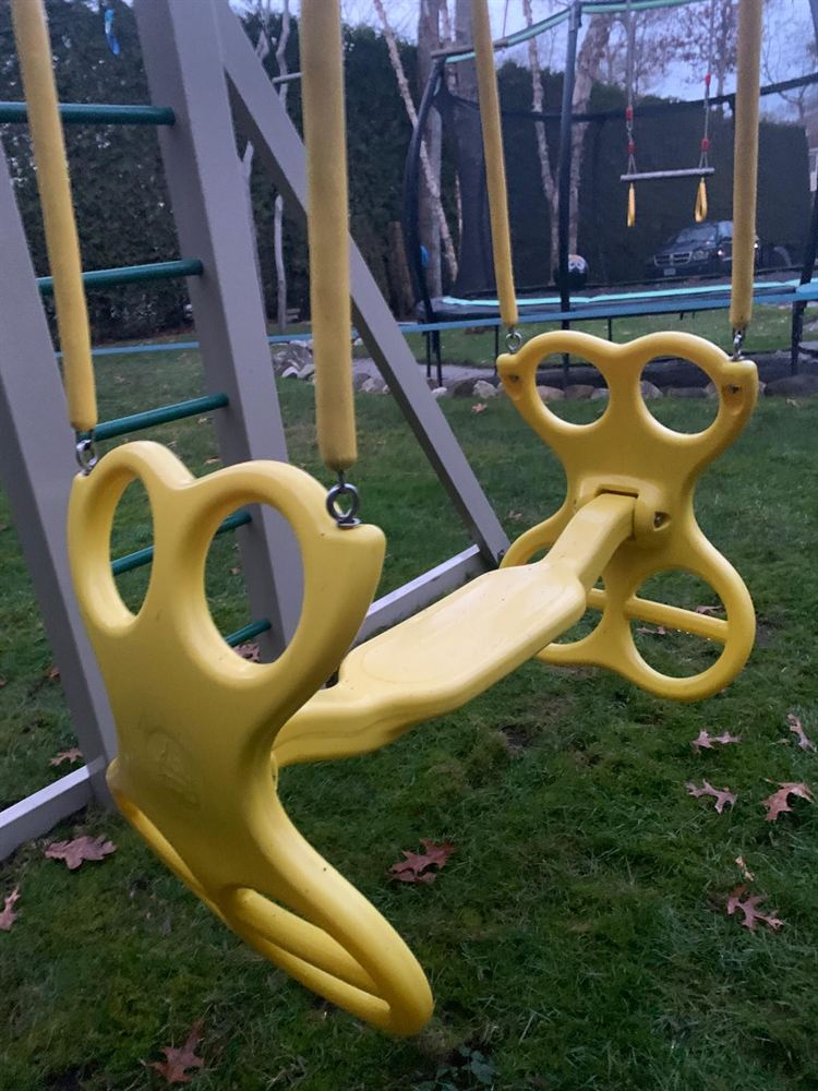 Bright clean yellow glider swing after power washing