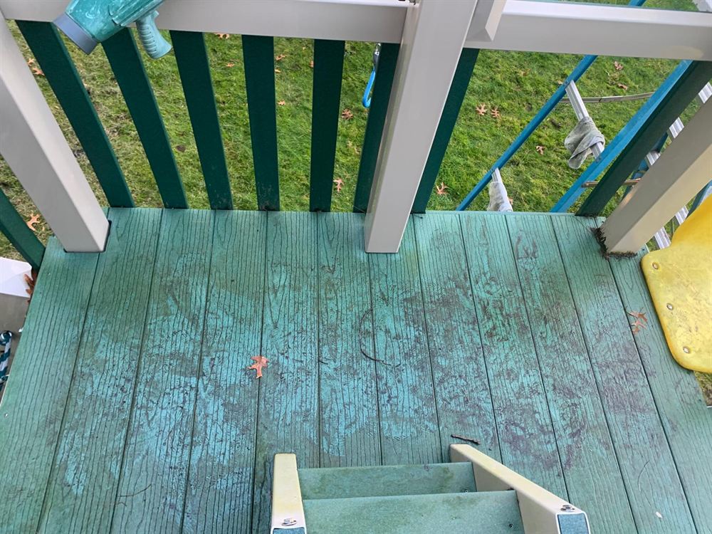 Weathered play set deck with mildew before power washing