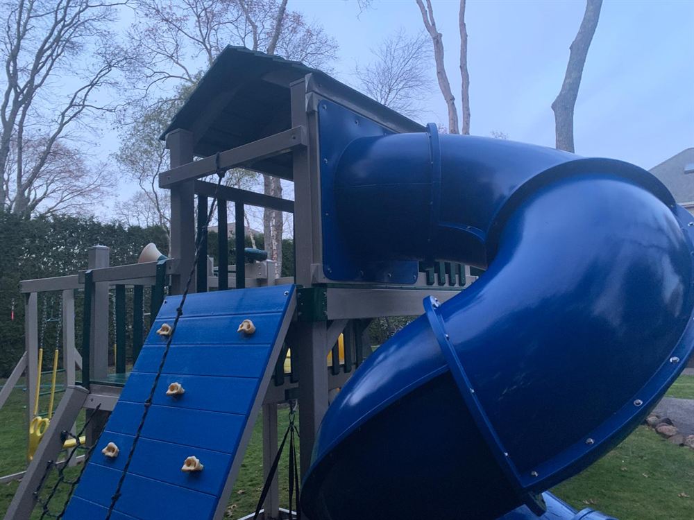 Clean play set fort and tube slide after power washing