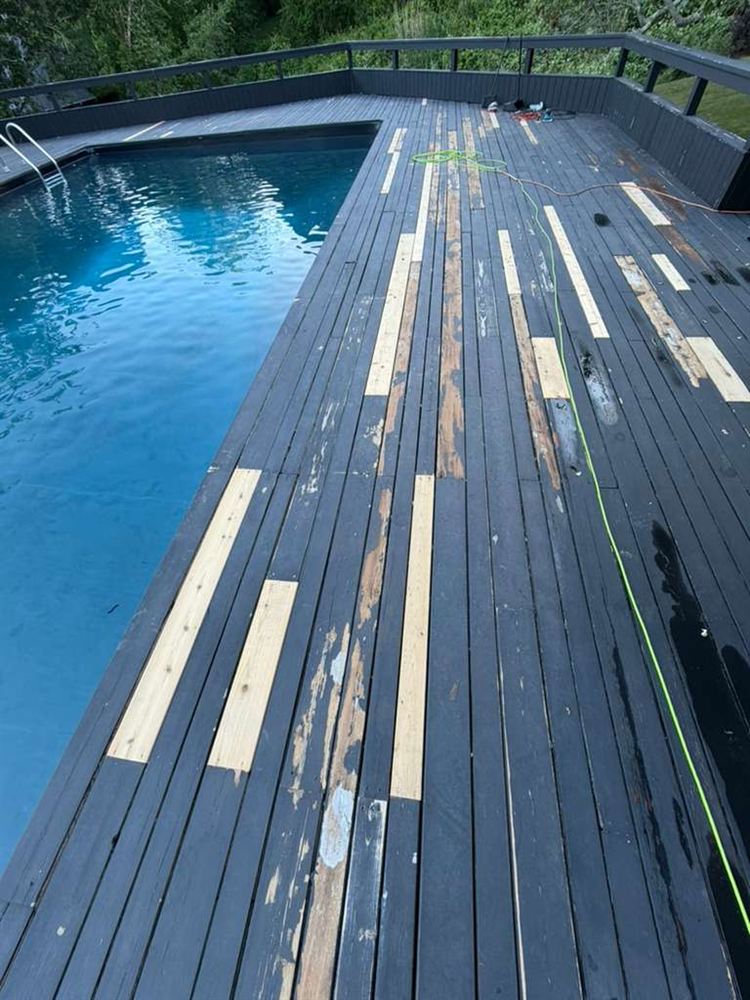 Sanded and repaired deck boards beside a pool before staining