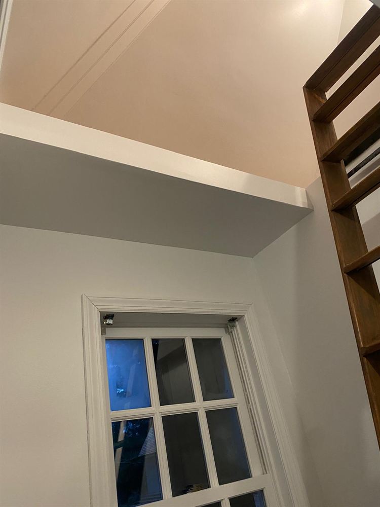 Repaired and repainted pool house wall and ceiling above the window