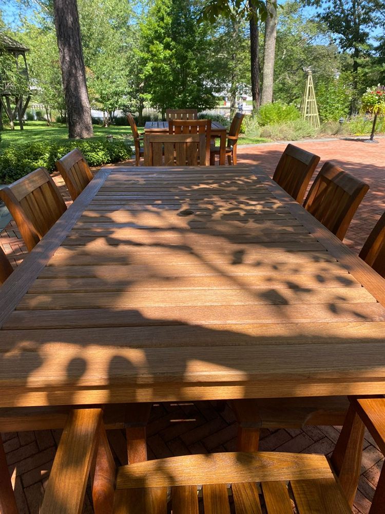 Restored teak dining table with a warm natural finish